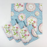 Set of cloth napkins featuring a blue background with vintage floral plate designs.