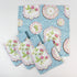 Set of cloth napkins featuring a blue background with vintage floral plate designs.