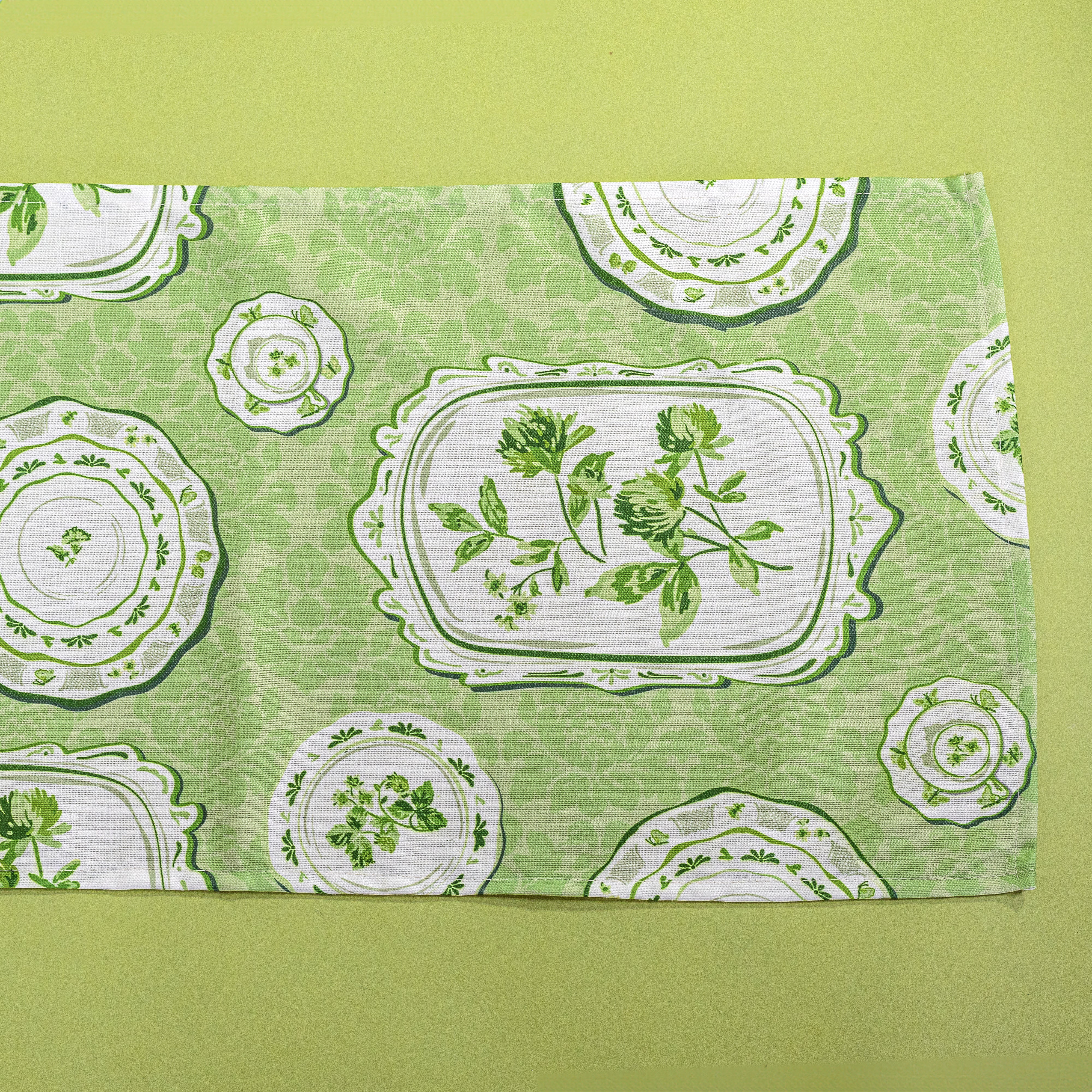 Green Sociey Hill Vintage Plates cloth table runner on a green background