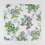 cloth napkins featuring a colorful botanical and bunny print on a white background.