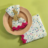 Springtime confetti multicolor cloth napkins from Madcap Cottage resting on a pink plate