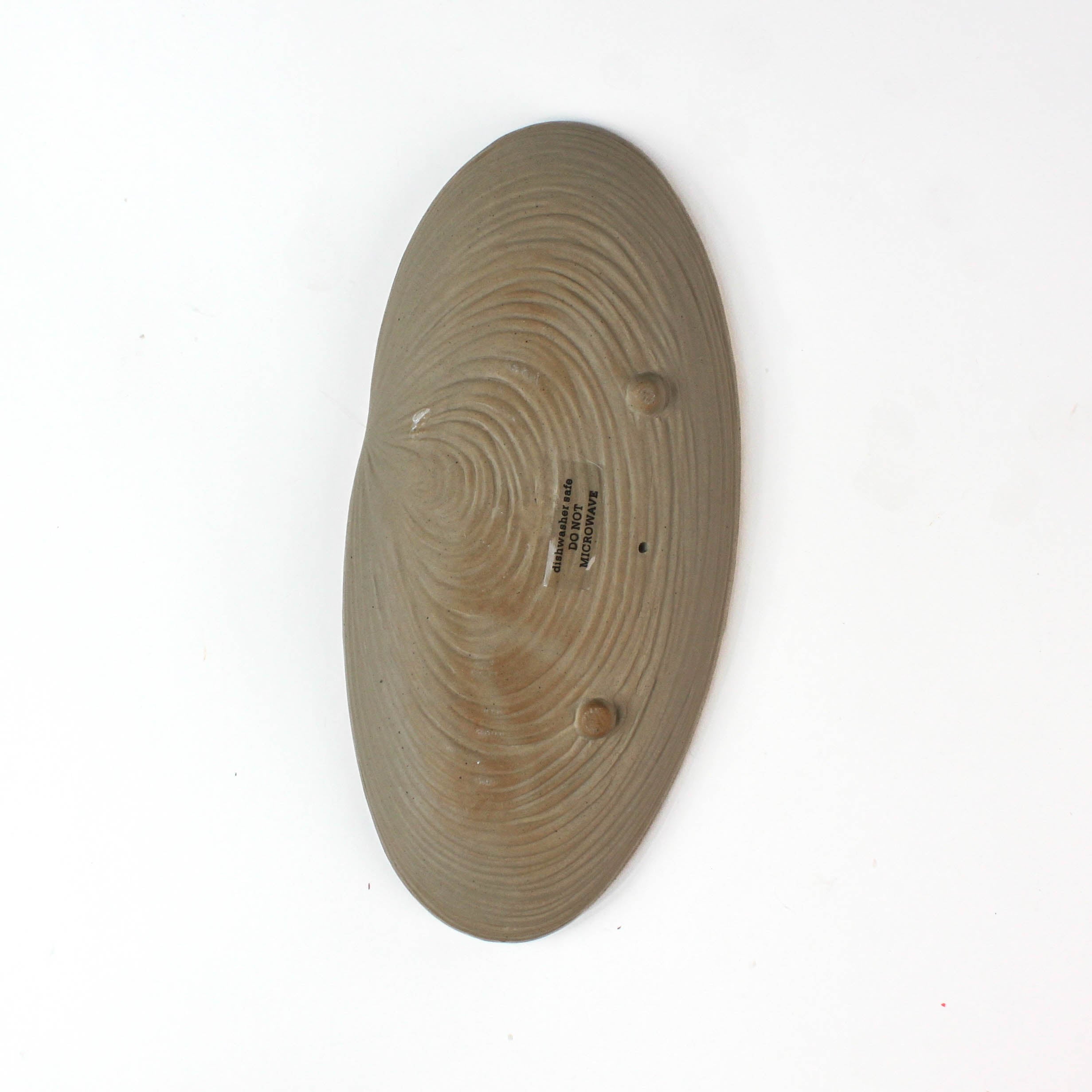 back of a Shell shaped plate cream colored