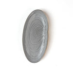 front of a Shell shaped plate cream colored