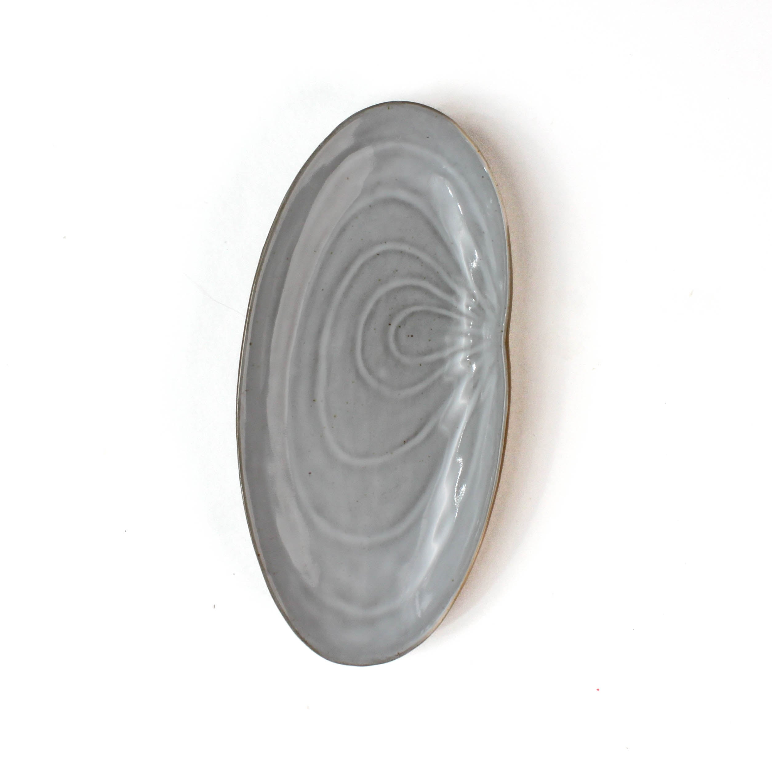 front of a Shell shaped plate cream colored