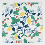 Cloth napkin laid flat with a botanical strawberry, lemon, and floral pattern.