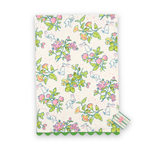Madcap Cottage Strawberry Spring Flowers cotton tea towel featuring colorful spring blossoms, playful white rabbits, green foliage, and green scalloped trim.