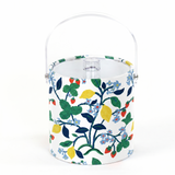 an acrylic ice bucket featuring a floral motif of lemons, strawberries and blue flowers on a white background, 