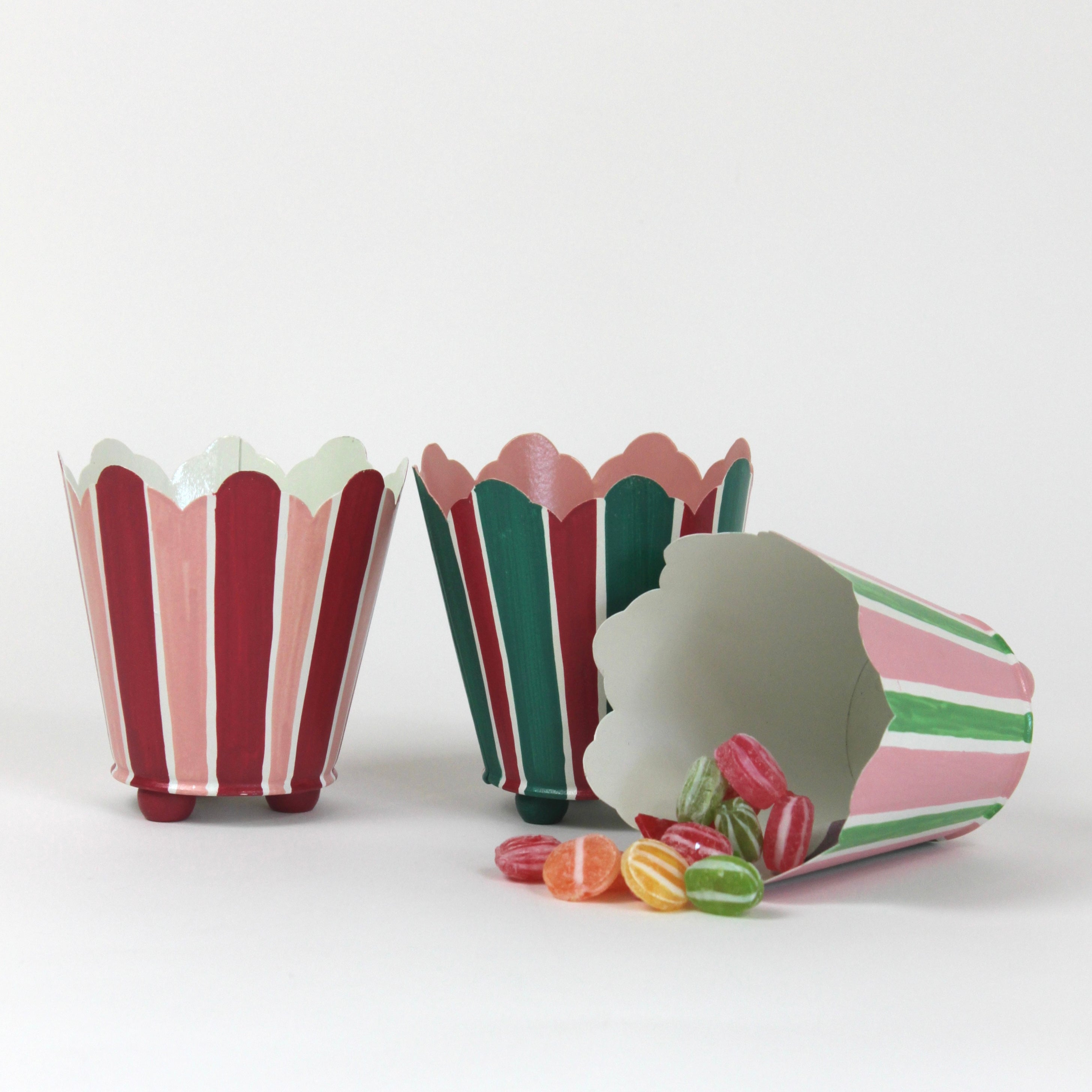 three striped cachepots in shades of pink, red and green from madcap cottage