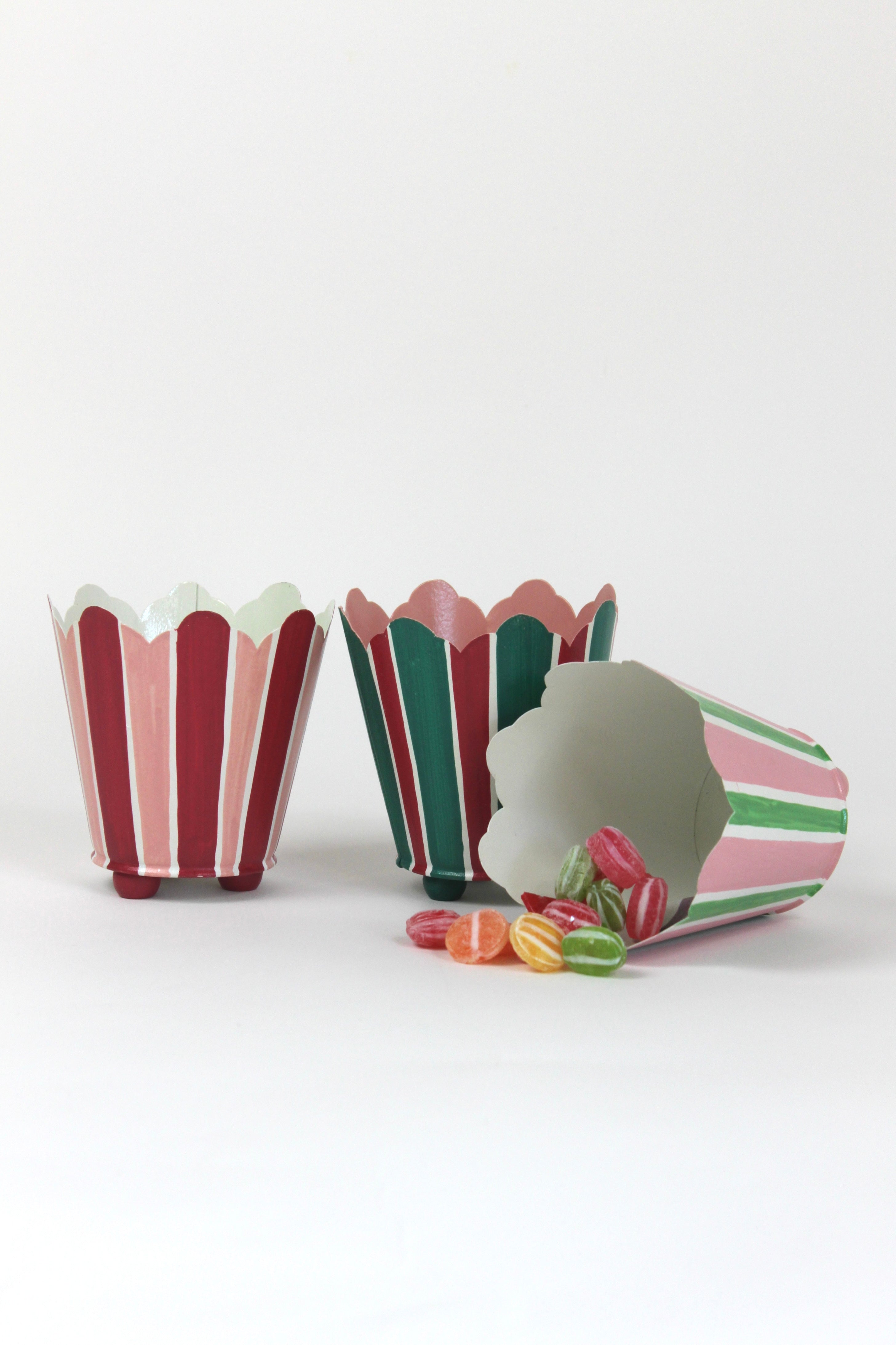 three striped cachepots in shades of pink, red and green from madcap cottage