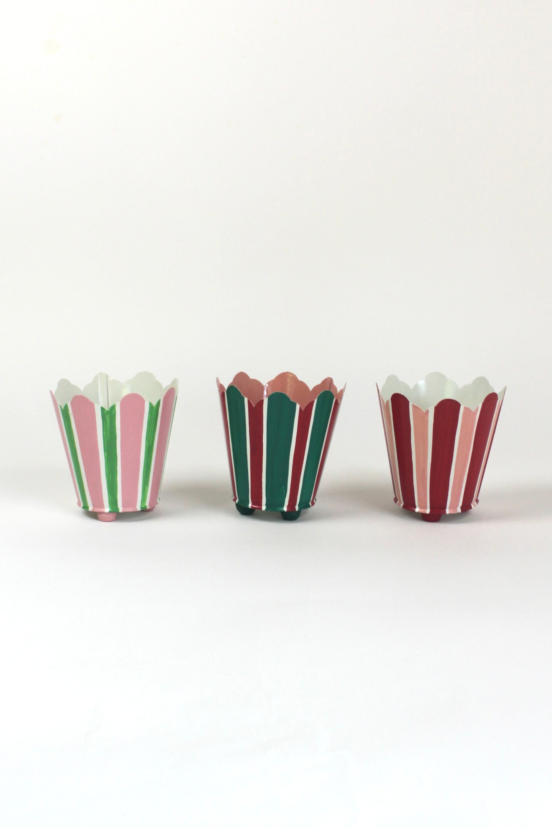 three striped cachepots in shades of pink, red and green from madcap cottage