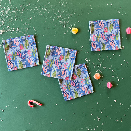 Sunken Gardens Flamingo cloth cocktail napkins. Set of four on a green background