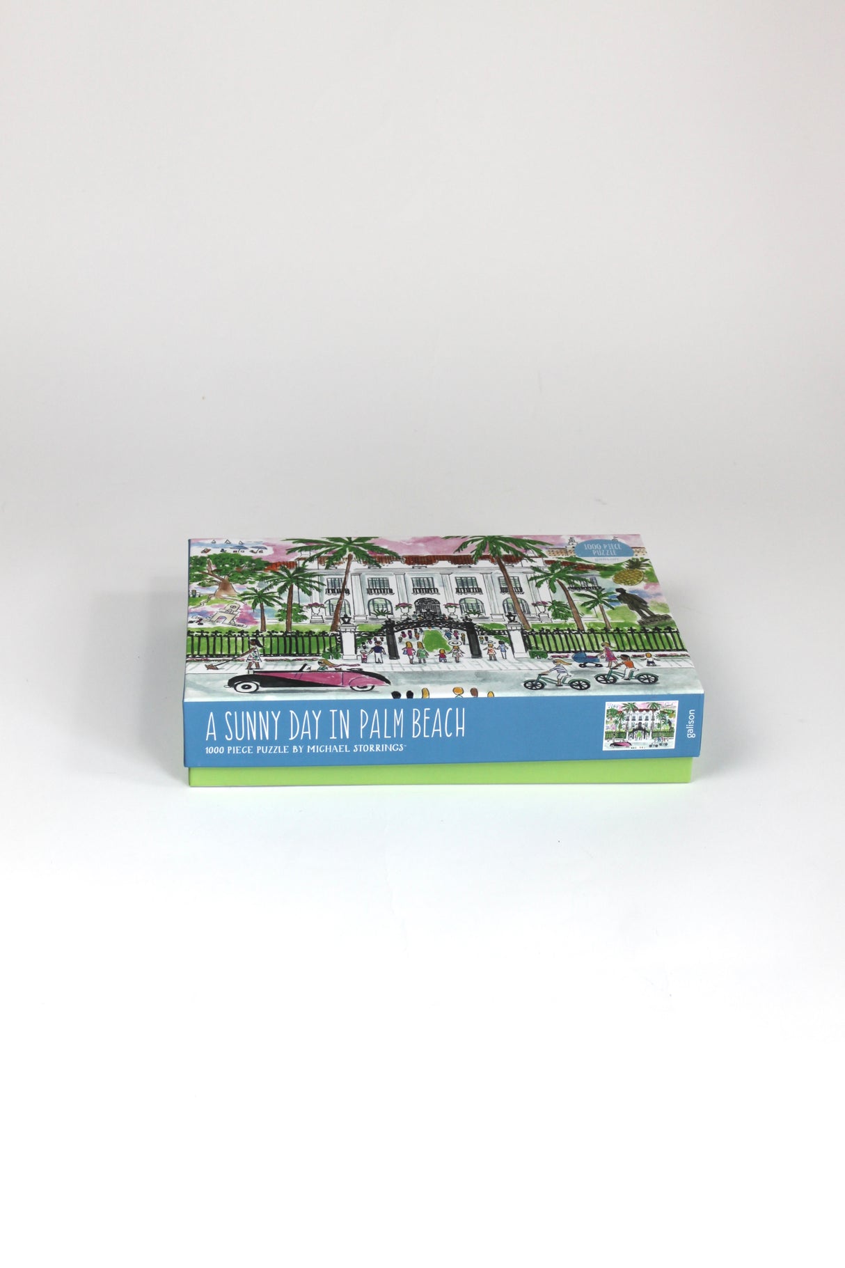 a 1000 piece jigsaw puzzle featuring an illustration of the a white building in palm beach florida. 