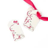 Swan Christmas gift tag featuring an elegant white swan, flowing pink ribbon, delicate bow accents, and printed To and From fields for personalized holiday gifting.