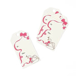 Swan Christmas gift tag featuring an elegant white swan, flowing pink ribbon, delicate bow accents, and printed To and From fields for personalized holiday gifting.