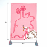 pink christmas tea towel featuring a large swan and pink ribbon design and blue and pink tassels with dimension 24" x 18.5" denoted with arrows