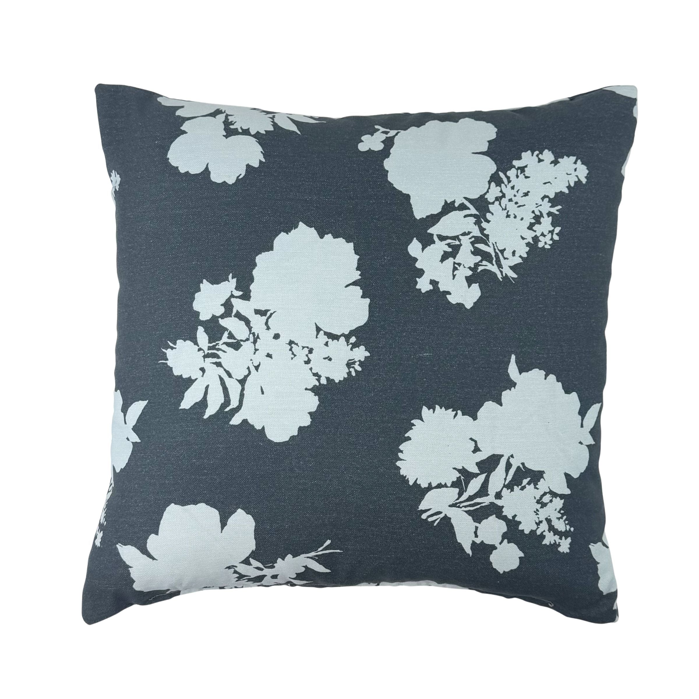 Navy blue floral outdoor pillow with elegant white blooms.