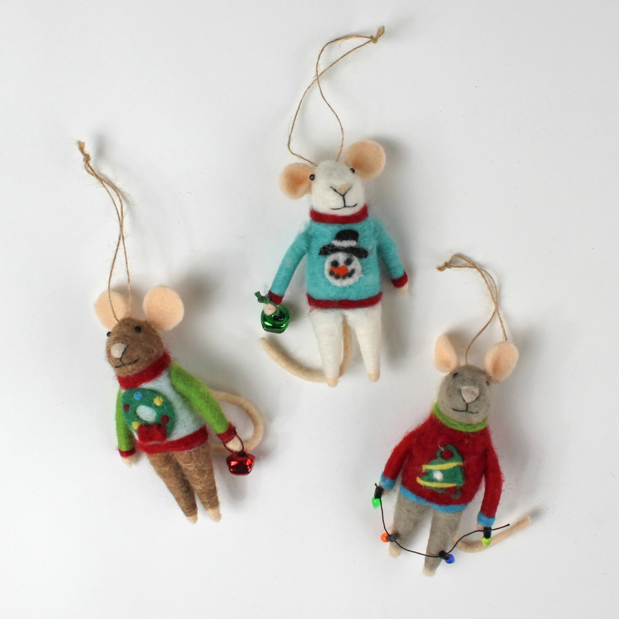 Three felt mouse ornaments dressed in colorful holiday sweaters—one with a snowman, one with a wreath, and one with a Christmas tree—each holding a gift.