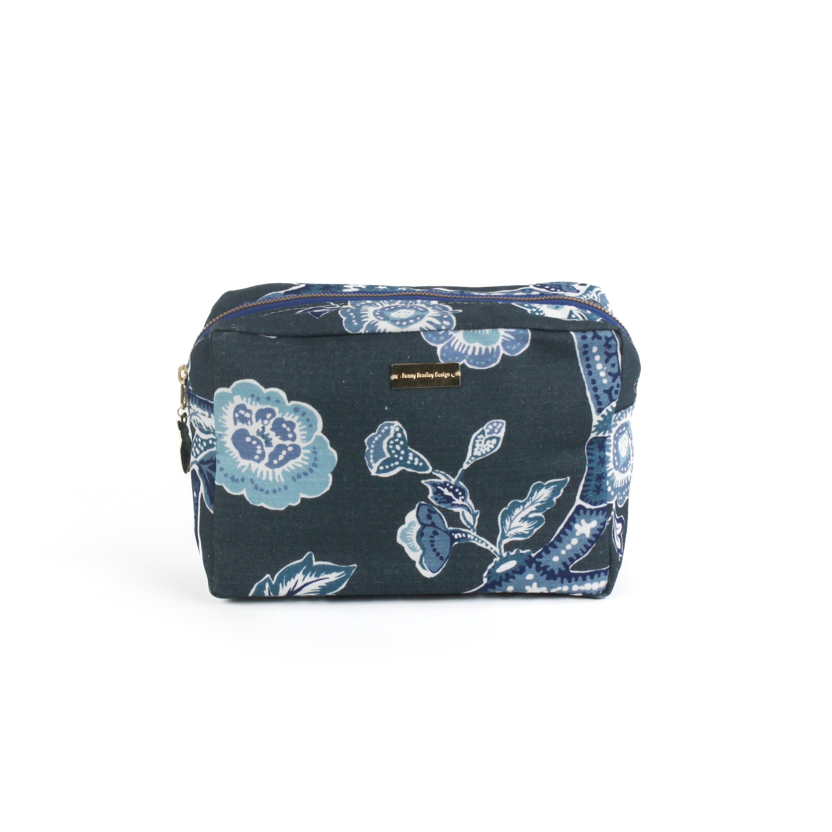 a large Temple Garden toiletry bag in navy blue features light blue floral motif.