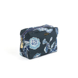 large Temple Garden toiletry bag in navy blue features light blue floral motif.