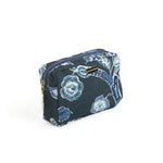 a side view of a medium Temple Garden toiletry bag in navy blue features light blue floral motif.