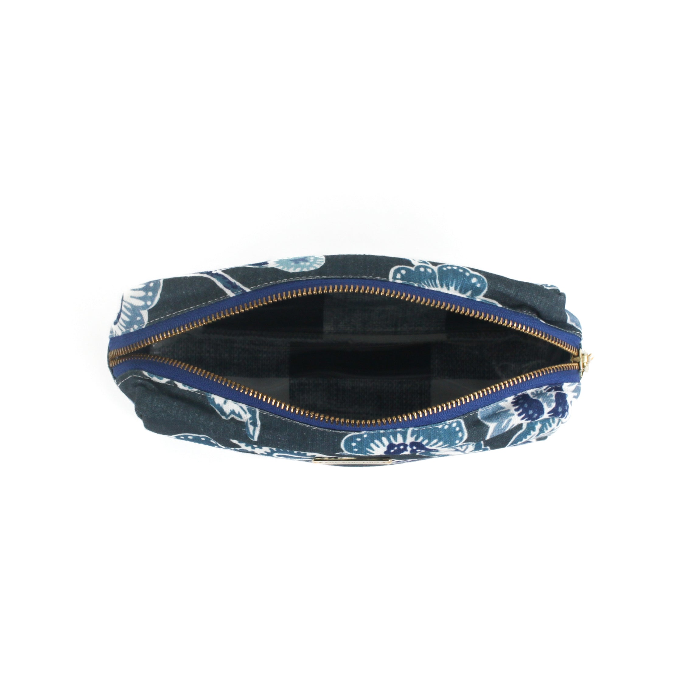 an inside view of a medium Temple Garden cosmetic/toiletry bag in navy blue features light blue floral motif.