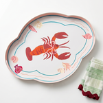 green, red and pink tray with a large central lobster design on a white background next to a green check napkin