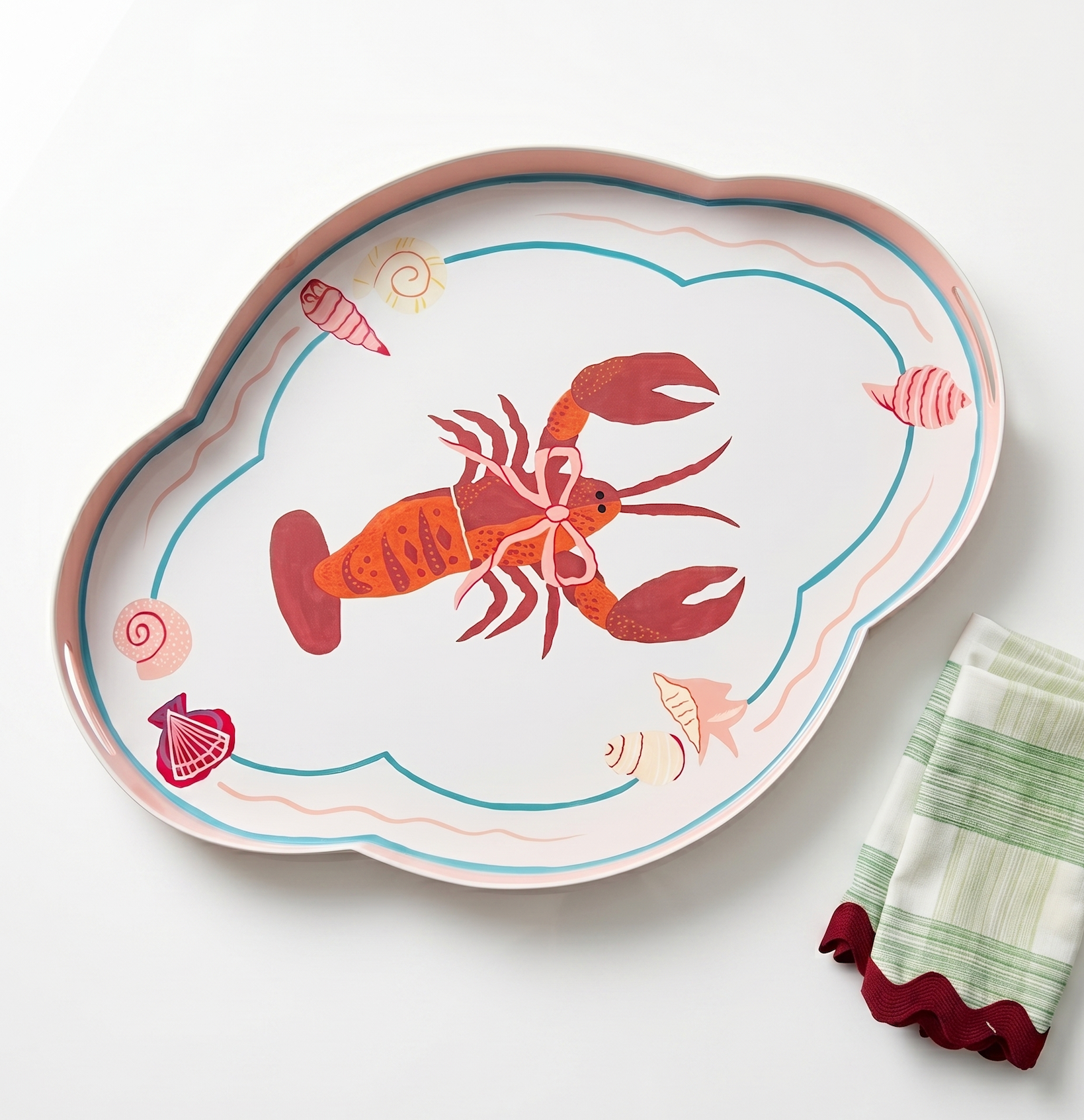 green, red and pink tray with a large central lobster design on a white background next to a green check napkin