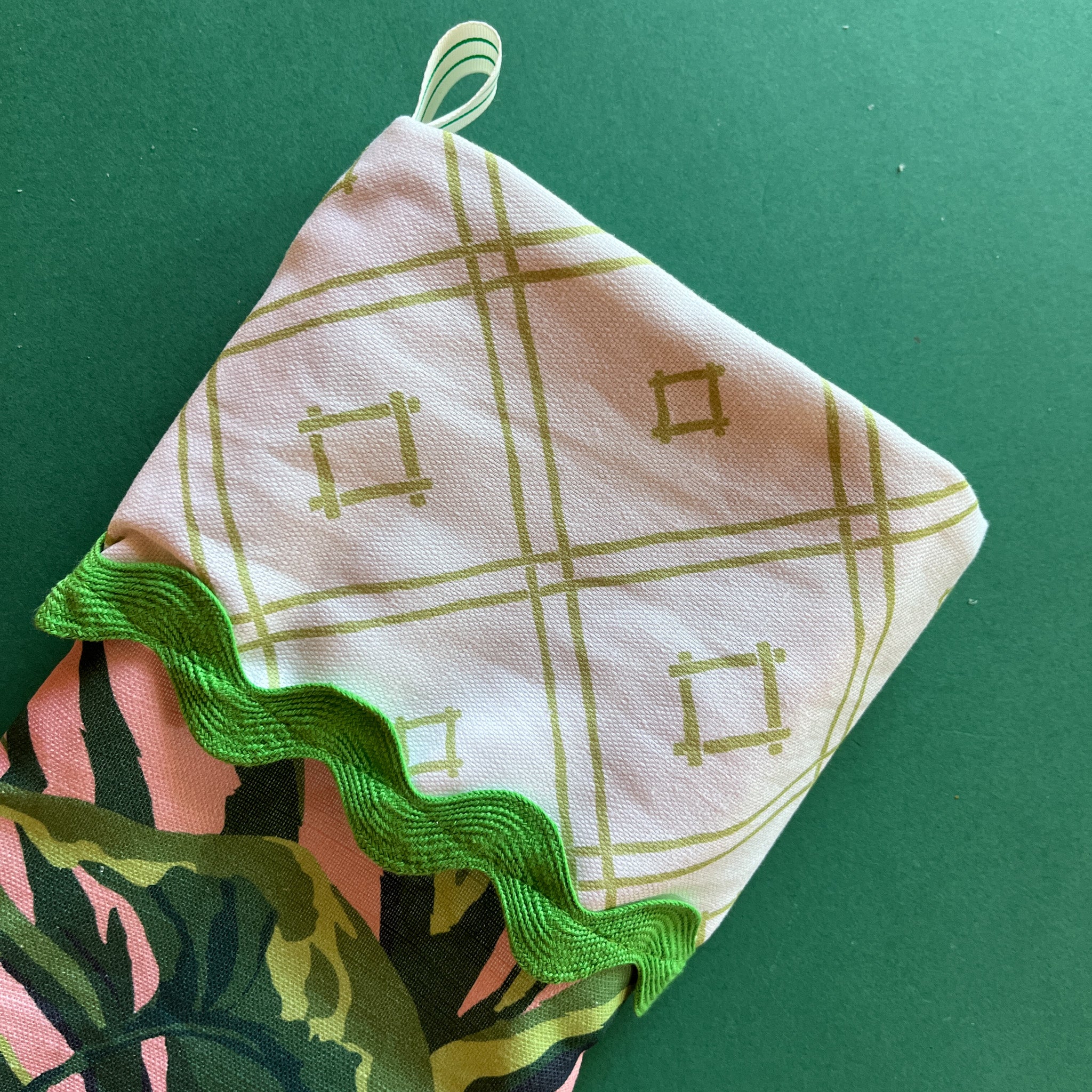 The fold top of a green Christmas stocking.