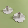 Top view of a pair of white scalloped ceramic candleholders