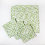 Set of cloth napkins with a light green floral pattern arranged together.