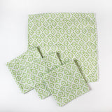 Set of cloth napkins with a light green floral pattern arranged together.