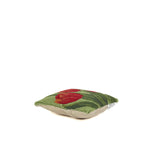 flat hooked pillow with red tulip floral design on green background