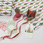 white and green wrapping paper printed with decorated christmas tree motifs