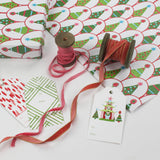 white and green wrapping paper printed with decorated christmas tree motifs