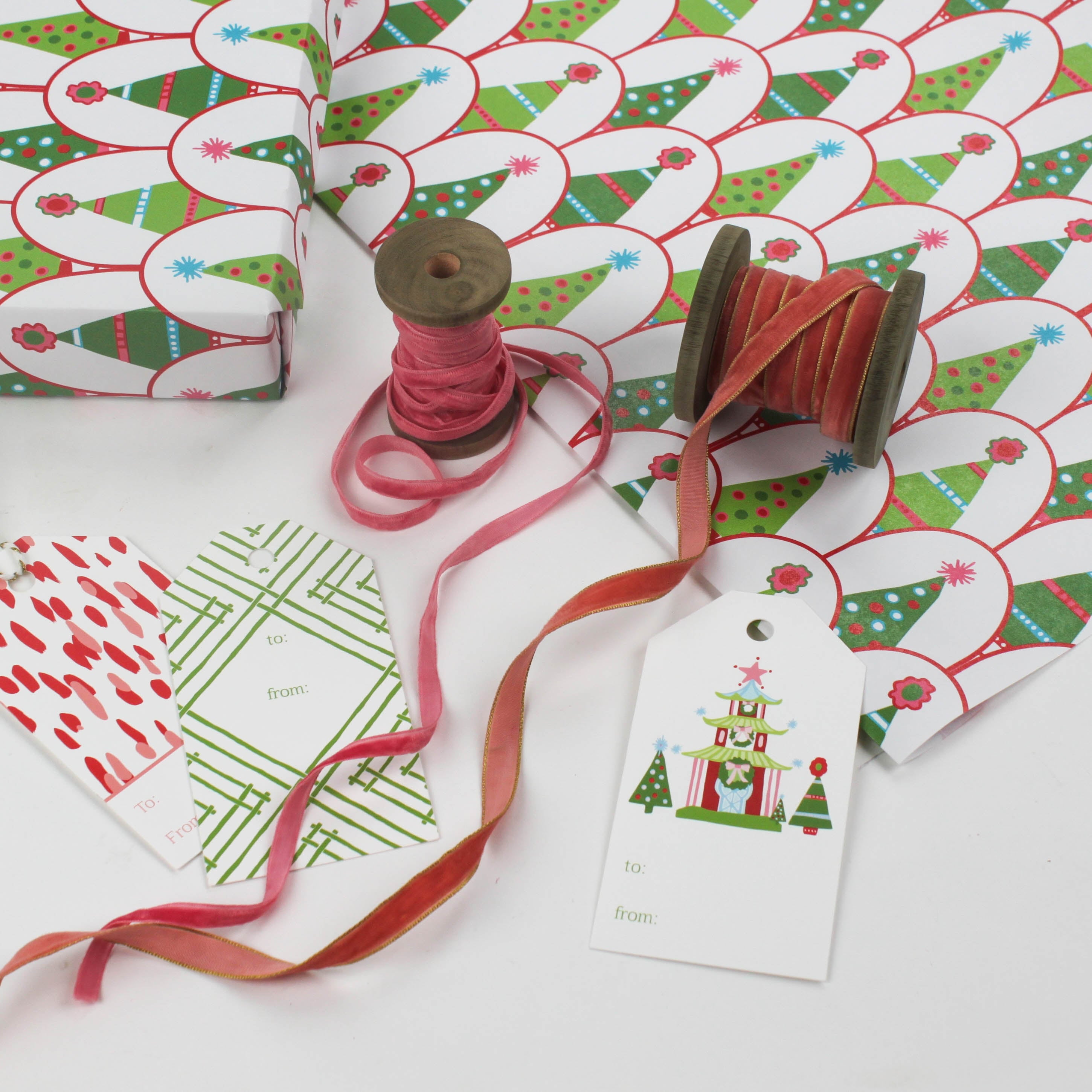white and green wrapping paper printed with decorated christmas tree motifs