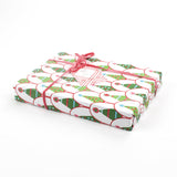 Gift wrapped in Twinkle Trees Christmas wrapping paper with pink ribbon and matching gift tag.