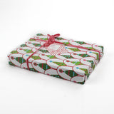 white and green wrapping paper printed with decorated christmas tree motifs