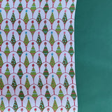 white and green wrapping paper printed with decorated christmas tree motifs