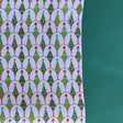 white and green wrapping paper printed with decorated christmas tree motifs