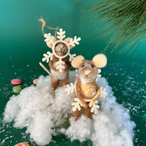 Two felt mice ornaments standing in fake snow