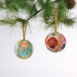Set of two velvet Christmas ball ornaments in soft pink and mint green, beautifully hand-embroidered with beaded floral designs and finished with gold braided trim and hanging loops
