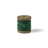 a dark green Velvet Ribbon on Wood Spool in a white background