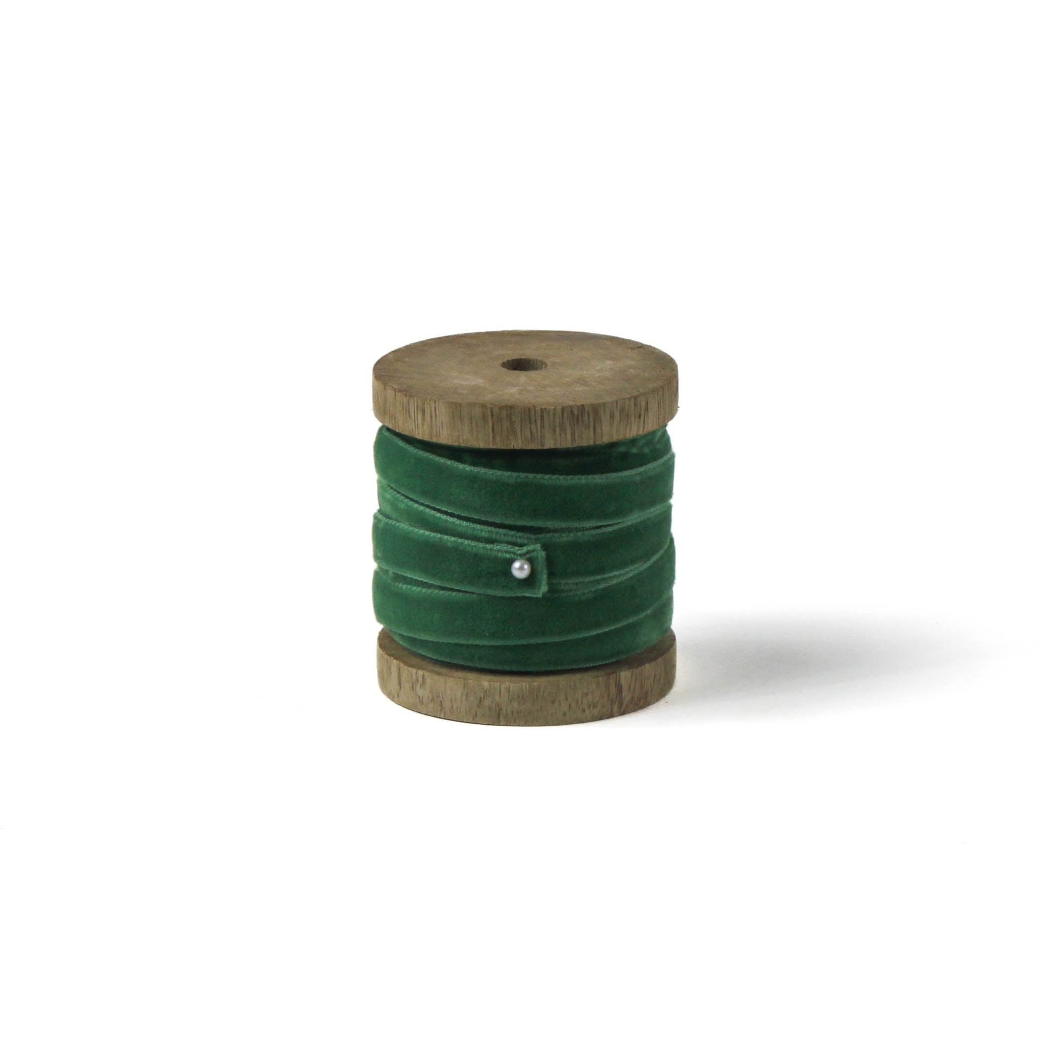 a dark green Velvet Ribbon on Wood Spool in a white background