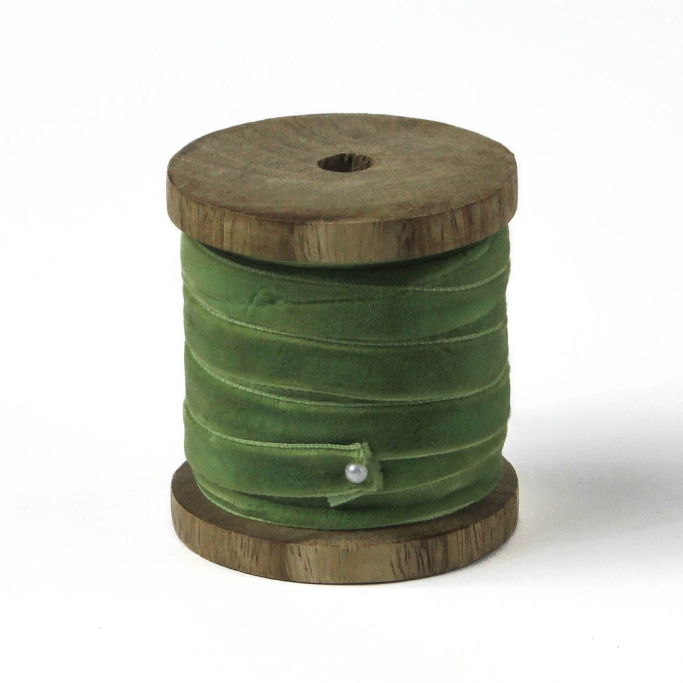 a light green Velvet Ribbon on Wood Spool in a white background