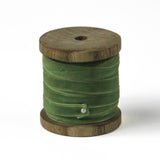 a light green Velvet Ribbon on Wood Spool in a white background
