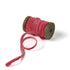 a pink Velvet Ribbon on Wood Spool in a white background