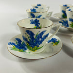Vintage English bone china cup, saucer, and dessert plate with bluebell floral pattern and gold rim
