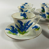 Vintage English bone china cup, saucer, and dessert plate with bluebell floral pattern and gold rim