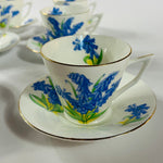 Vintage English bone china cup, saucer, and dessert plate with bluebell floral pattern and gold rim