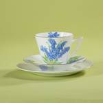 Vintage English bone china cup, saucer, and dessert plate with bluebell floral pattern and gold rim